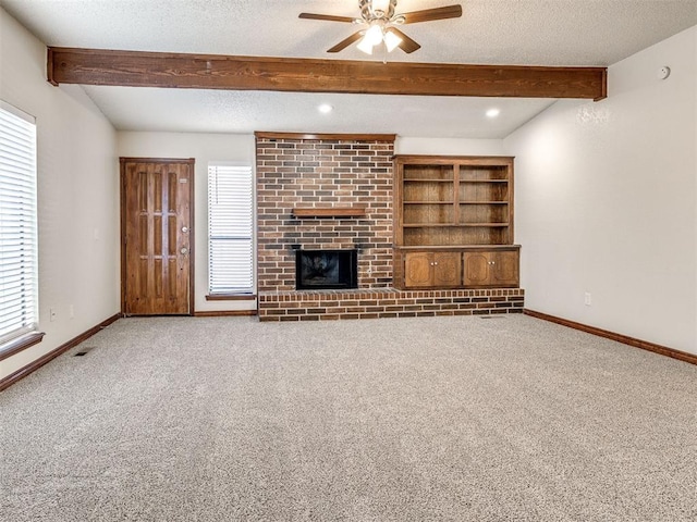 unfurnished living room featuring carpet, plenty of natural light, and a textured ceiling