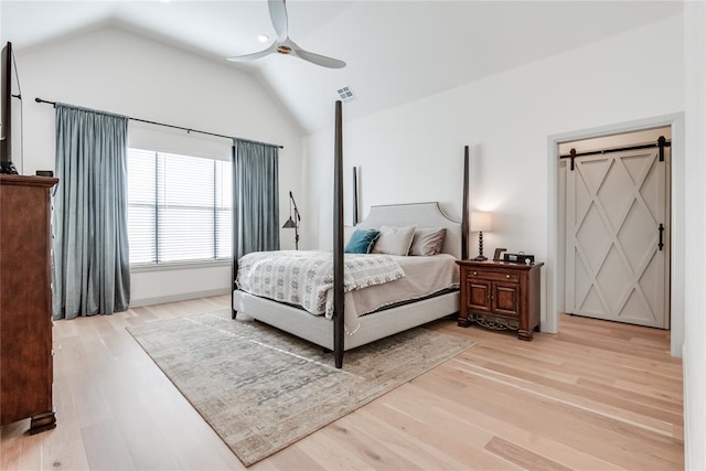 bedroom with light hardwood / wood-style floors, vaulted ceiling, and ceiling fan