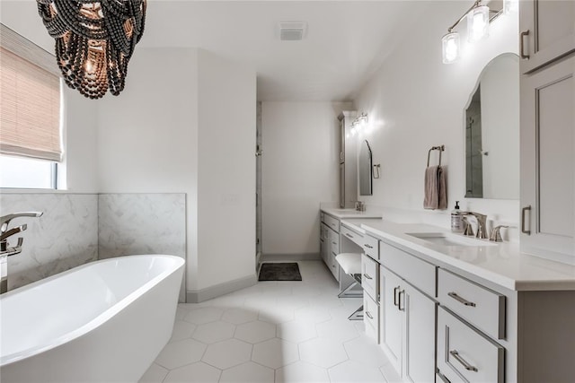 bathroom featuring tile patterned flooring, vanity, and independent shower and bath