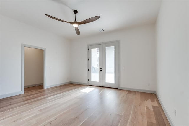 spare room with ceiling fan, french doors, and light wood-type flooring