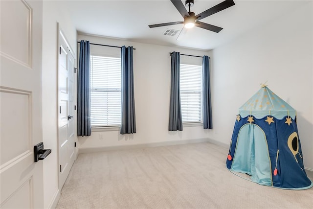 misc room with light carpet, a wealth of natural light, and ceiling fan