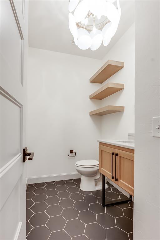 bathroom with tile patterned floors, vanity, and toilet