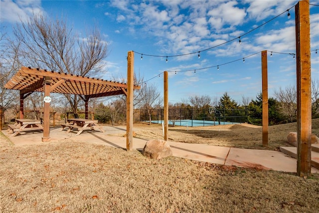 view of yard featuring a pergola and tennis court