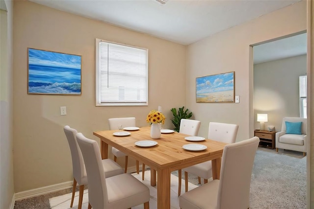 dining area with light colored carpet