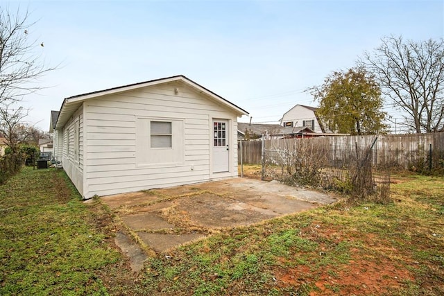 rear view of property featuring a patio and a yard