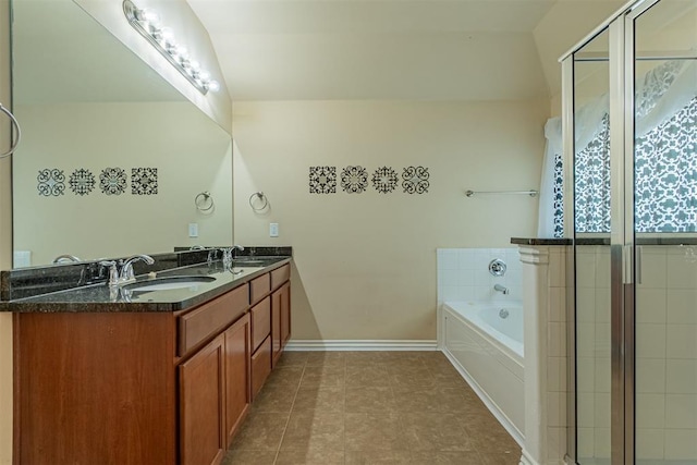 bathroom with tile patterned floors, vanity, and tiled tub