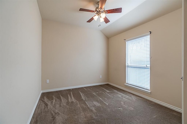 carpeted empty room with ceiling fan and vaulted ceiling