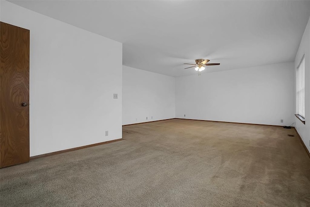 spare room with carpet and ceiling fan