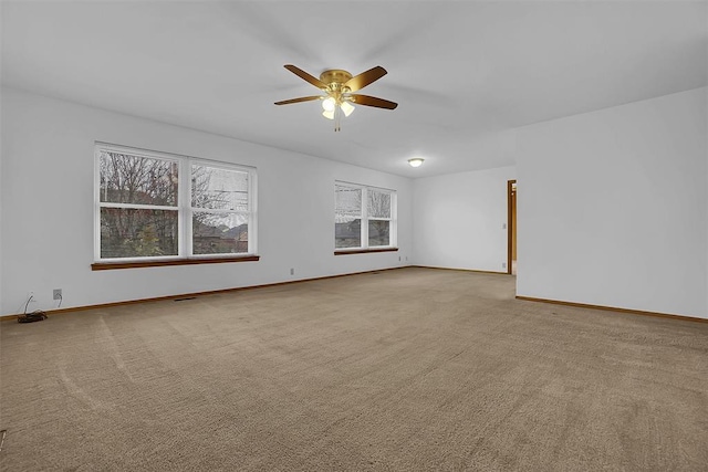 unfurnished room featuring ceiling fan and light colored carpet