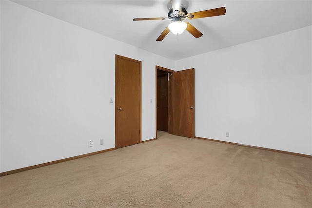 carpeted empty room featuring ceiling fan