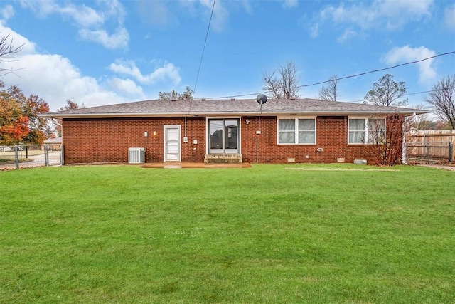 back of house featuring a yard and central AC unit