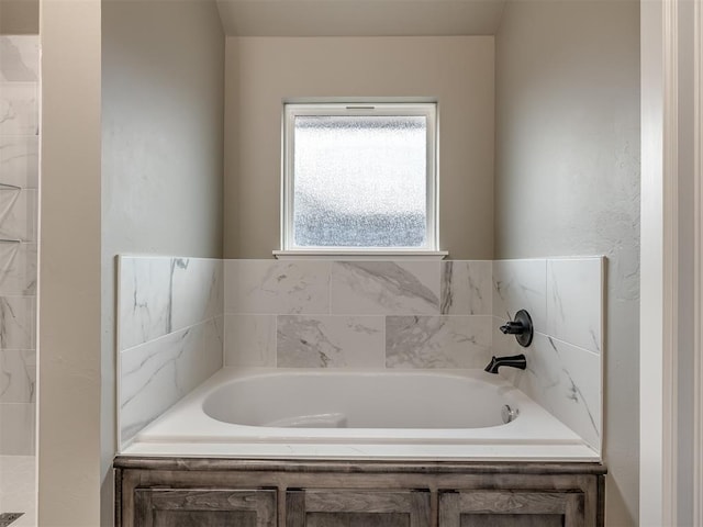 bathroom featuring a relaxing tiled tub