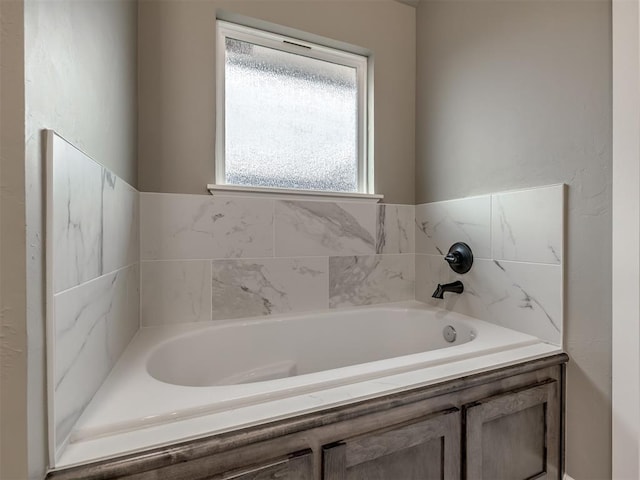 bathroom with tiled bath