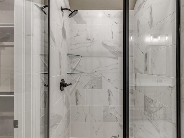 bathroom featuring a shower with door