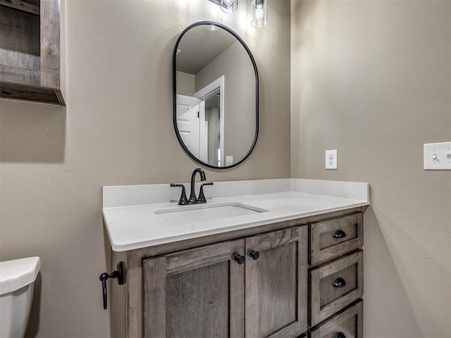 bathroom with vanity and toilet