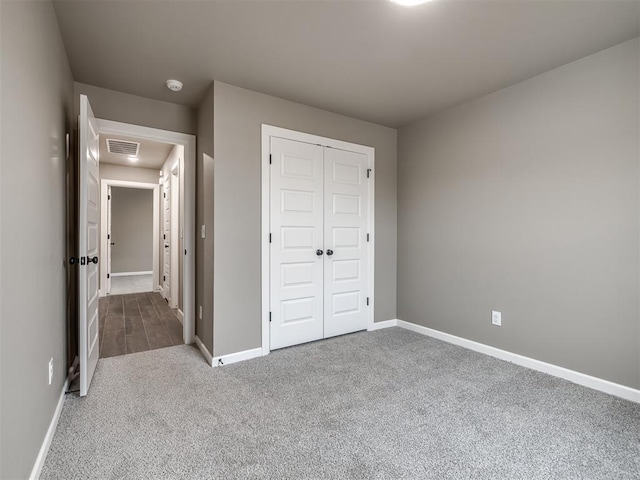 unfurnished bedroom with carpet floors and a closet