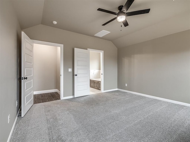 unfurnished bedroom with ceiling fan, lofted ceiling, carpet flooring, and ensuite bathroom