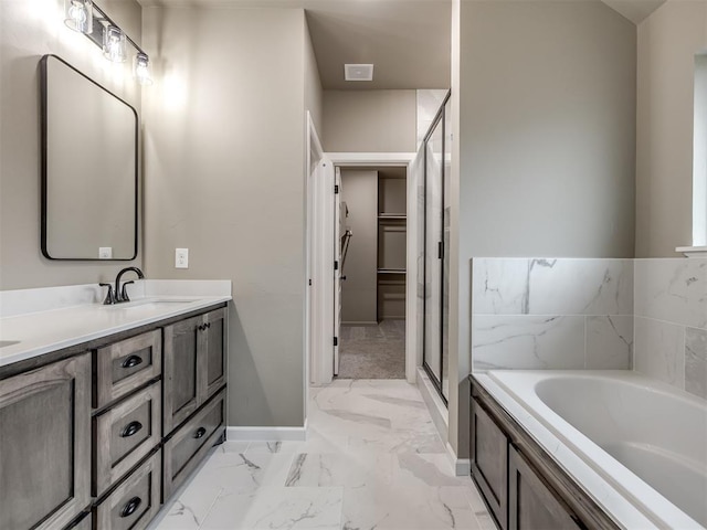 bathroom with vanity and shower with separate bathtub