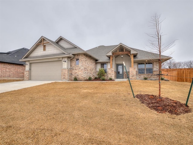 craftsman house featuring a garage and a front lawn