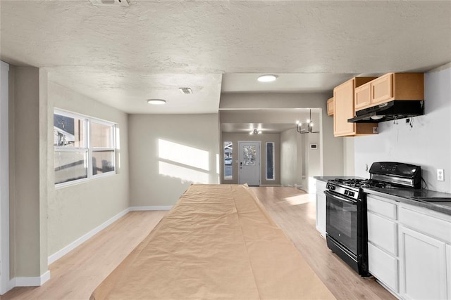 kitchen with pendant lighting, light brown cabinets, an inviting chandelier, light wood-type flooring, and black range with gas cooktop