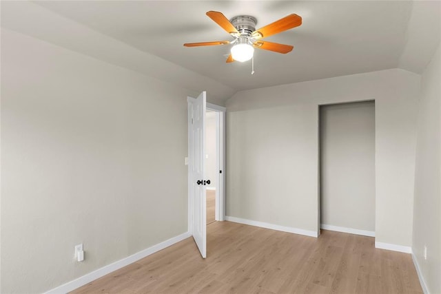 unfurnished bedroom with ceiling fan, lofted ceiling, and light hardwood / wood-style flooring