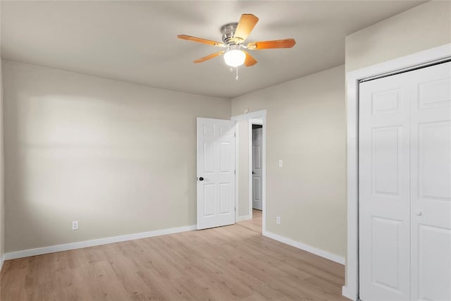 unfurnished bedroom featuring light wood-type flooring, a closet, and ceiling fan