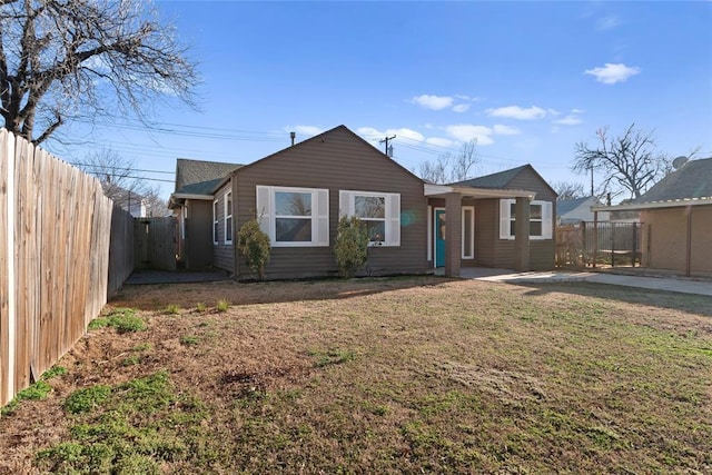 view of front of home with a front yard and a fenced backyard