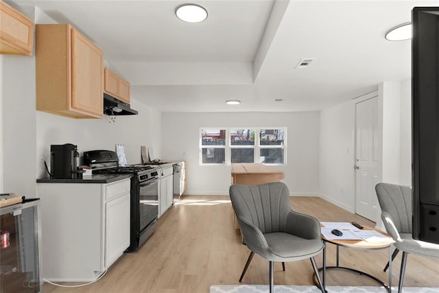 kitchen featuring visible vents, light brown cabinets, under cabinet range hood, black gas range, and wine cooler