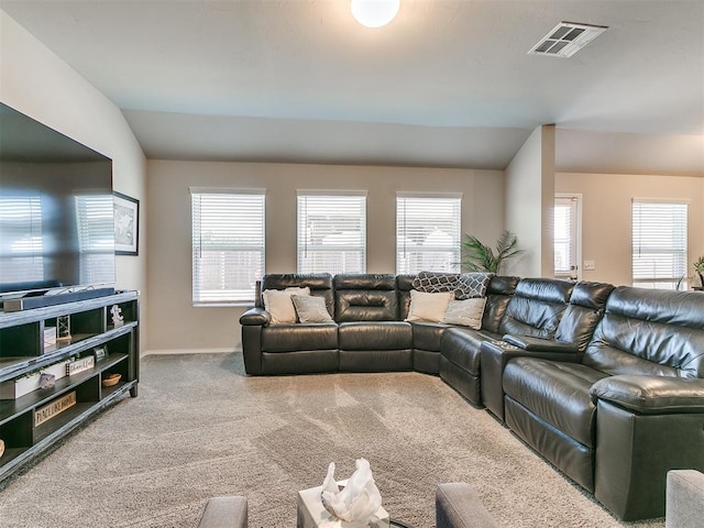 carpeted living room featuring lofted ceiling