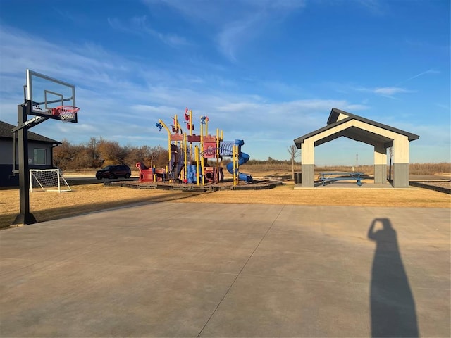 view of playground with basketball hoop