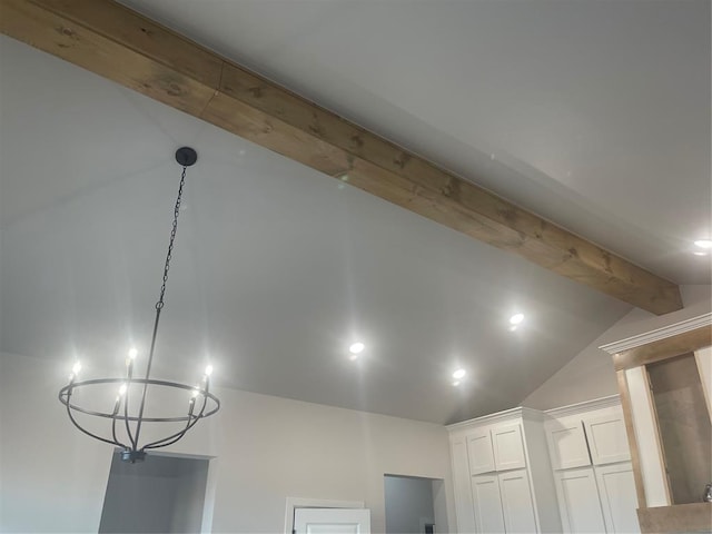 interior details featuring a notable chandelier and beam ceiling