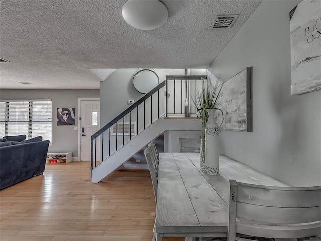 interior space with a textured ceiling and light wood-type flooring