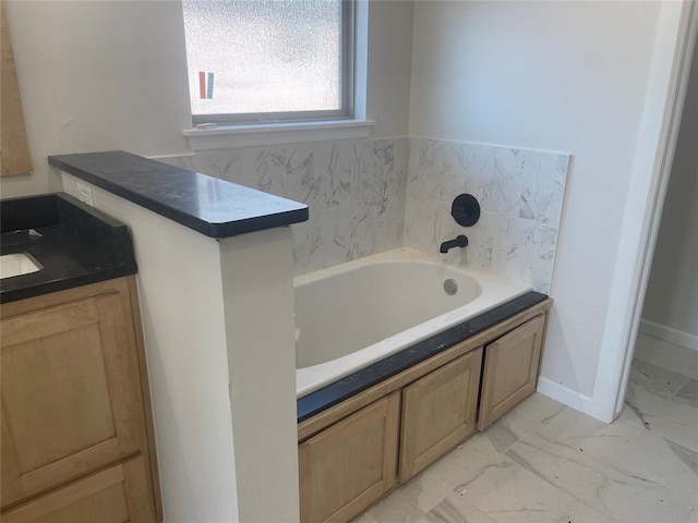 bathroom featuring vanity and a bath