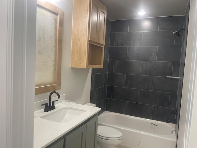 full bathroom featuring vanity, toilet, and tiled shower / bath combo