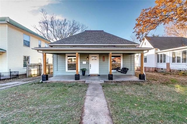 bungalow featuring a front lawn and covered porch