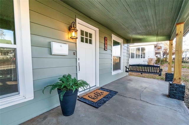 view of exterior entry featuring a porch