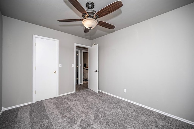 unfurnished bedroom with dark colored carpet and ceiling fan