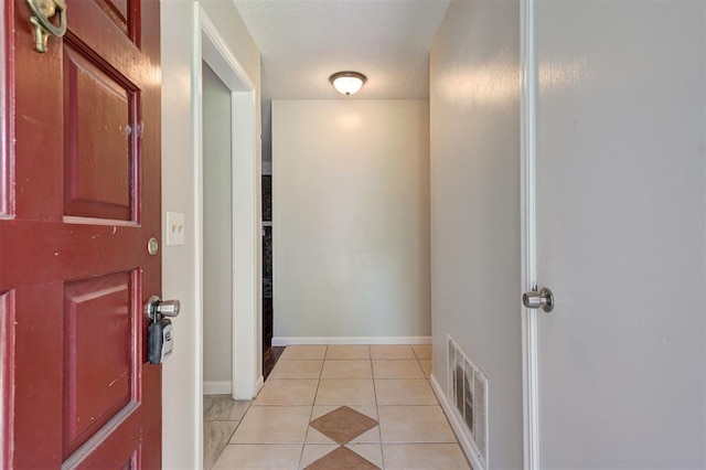 corridor with light tile patterned floors