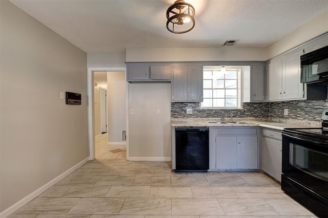 kitchen featuring gray cabinetry, sink, tasteful backsplash, a textured ceiling, and black appliances