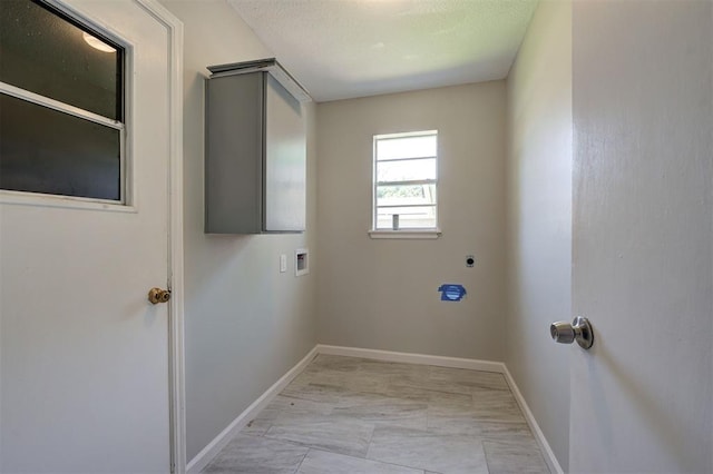 laundry room with a textured ceiling and hookup for a washing machine