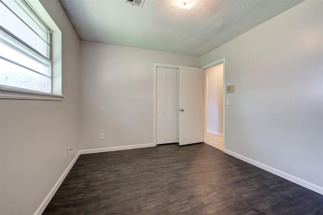 interior space with dark hardwood / wood-style flooring and a textured ceiling