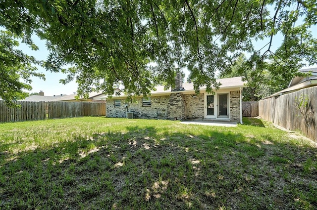 view of yard featuring central air condition unit and a patio