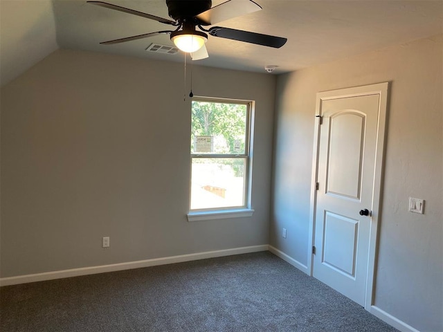 carpeted empty room featuring ceiling fan and vaulted ceiling