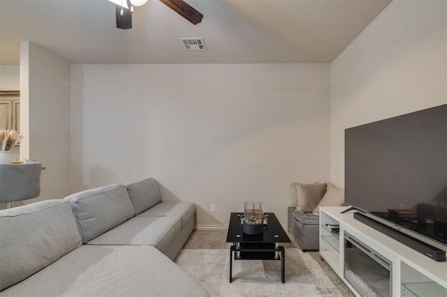 carpeted living room with ceiling fan