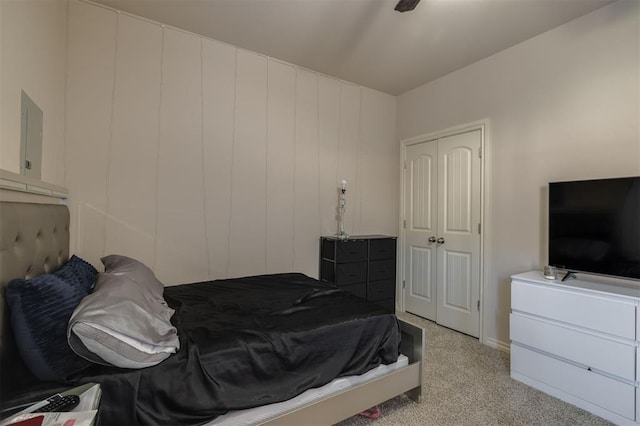 carpeted bedroom featuring ceiling fan and a closet