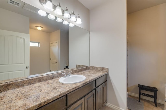 bathroom with tile patterned flooring and vanity