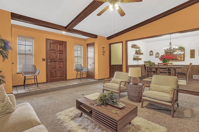 carpeted living room featuring ceiling fan with notable chandelier and lofted ceiling with beams