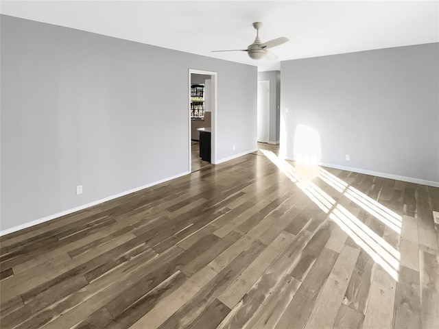 unfurnished living room featuring dark hardwood / wood-style floors and ceiling fan