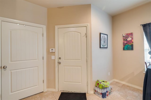 entryway with light tile patterned floors