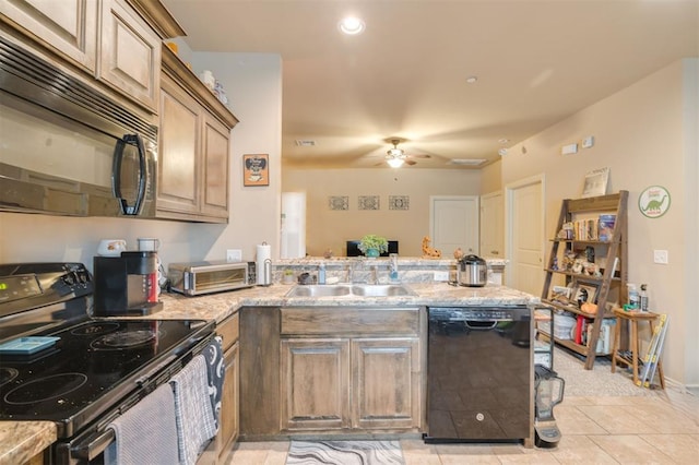 kitchen featuring black appliances, sink, ceiling fan, light tile patterned floors, and kitchen peninsula